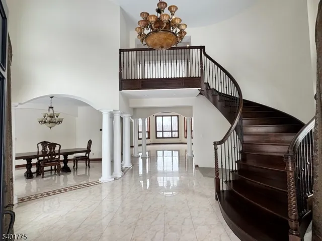 a view of entryway livingroom and hall with wooden floor