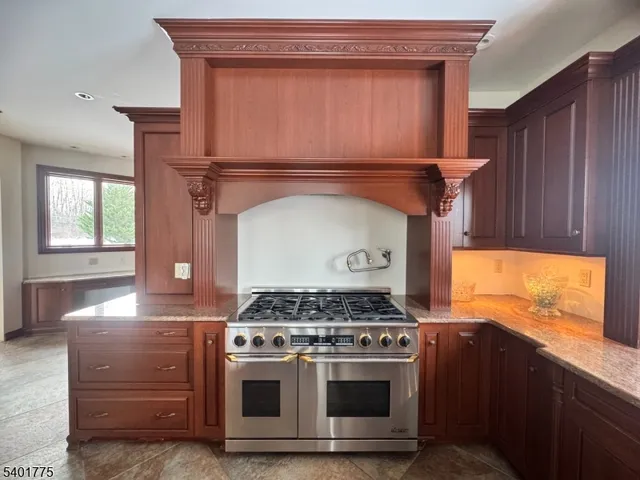 a stove top oven sitting inside of a kitchen