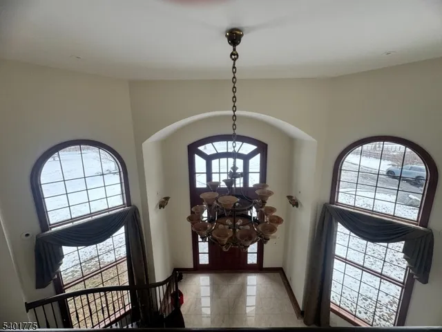 a view of hall way with furniture and front door