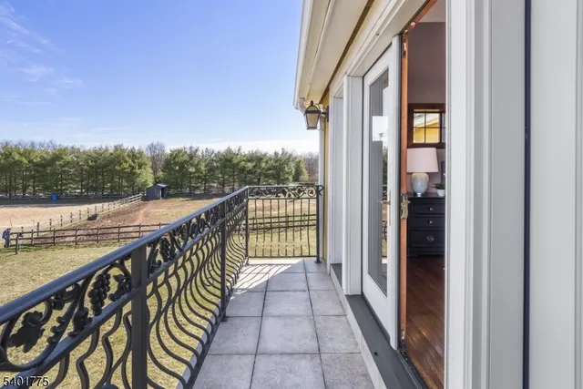 a view of a balcony with wooden floor and lake view