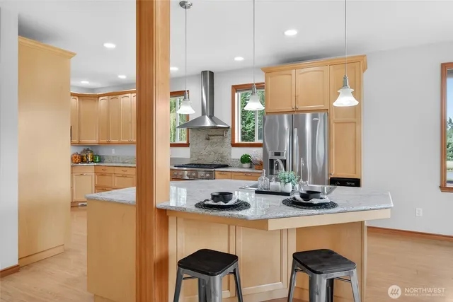 a kitchen with a stove a sink and a refrigerator