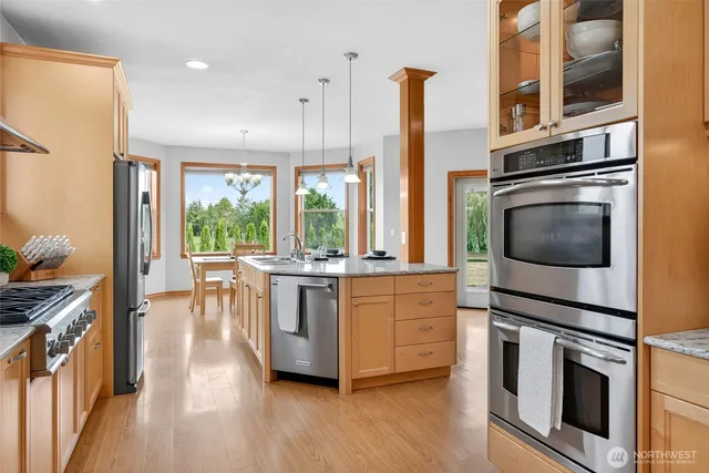 a living room with kitchen island furniture and a chandelier