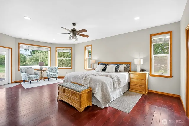 a spacious bedroom with a bed and a potted plant