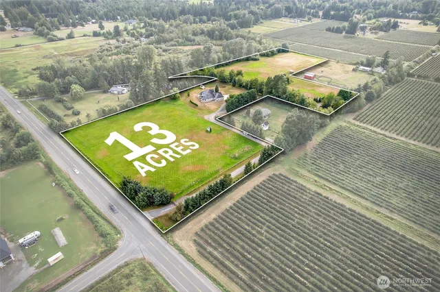 a view of a pool with lawn chairs