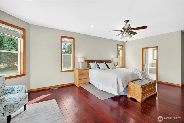 a bathroom with a granite countertop sink a mirror and shower