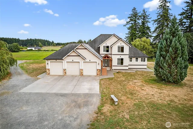a view of a house with swimming pool and a yard