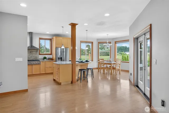 a kitchen with stainless steel appliances granite countertop a refrigerator a oven and a sink