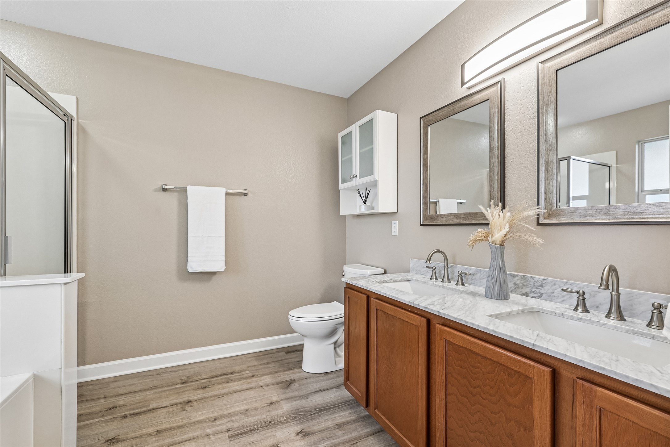 152 Grant Way Kyle, TX 78640 - Photo 26 of 39 a bathroom with a double vanity sink toilet and mirror