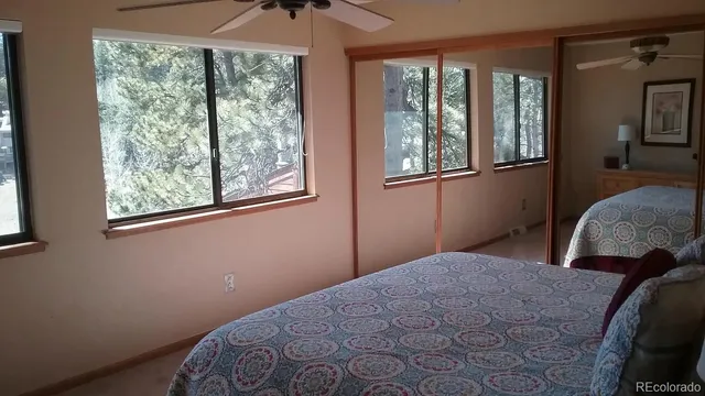 a view of bedroom with window and hallway