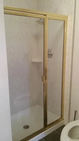 a bathroom with a toilet and a mirror