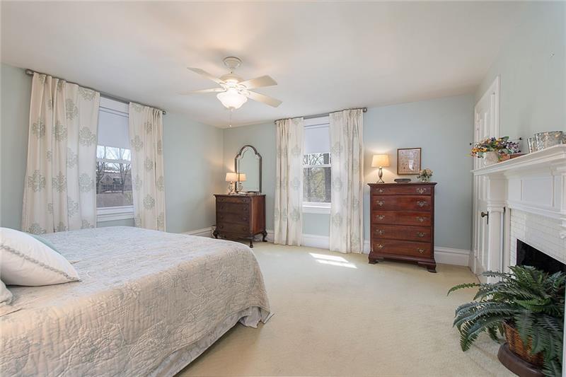 304 Quaker Road Sewickley, PA 15143 - Photo 12 of 25 The master bedroom boasts large windows, a high ceiling, and a decorative fireplace.