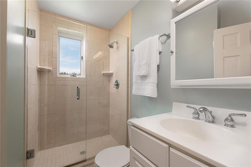 304 Quaker Road Sewickley, PA 15143 - Photo 17 of 25 Another full bathroom on the 2nd level has a glass-enclosed tiled shower.