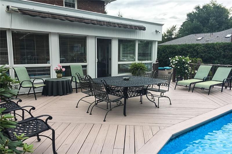 304 Quaker Road Sewickley, PA 15143 - Photo 23 of 25 The outdoor deck with retractable awning wraps around the back of the home.