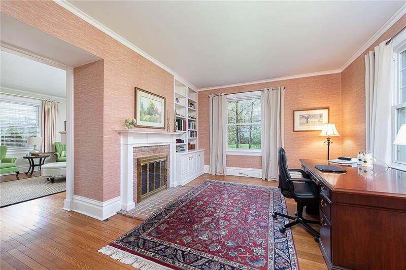 304 Quaker Road Sewickley, PA 15143 - Photo 6 of 25 The den with fireplace and built-in shelves is currently being used as an office.