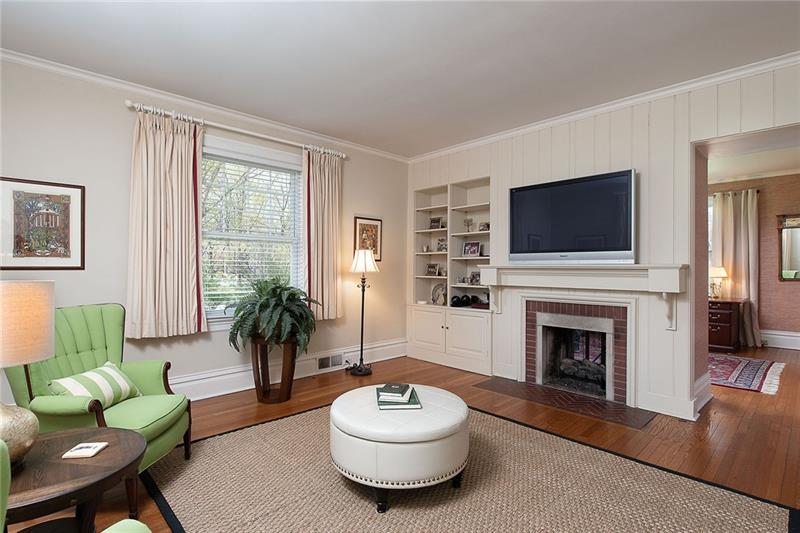 304 Quaker Road Sewickley, PA 15143 - Photo 7 of 25 Connected to the den, the family room shares a double-sided gas fireplace.