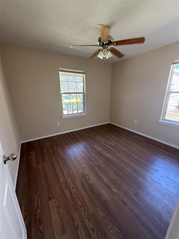 900 Reese Lane Azle, TX 76020 - Photo 11 of 15 a view of an empty room with wooden floor and a window