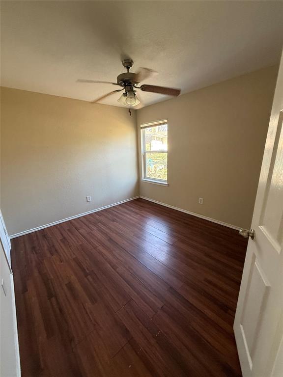 900 Reese Lane Azle, TX 76020 - Photo 12 of 15 an empty room with a window and wooden floor