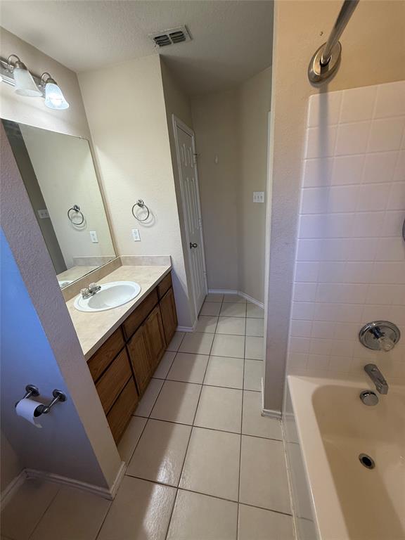 900 Reese Lane Azle, TX 76020 - Photo 14 of 15 a bathroom with a bathtub sink and mirror