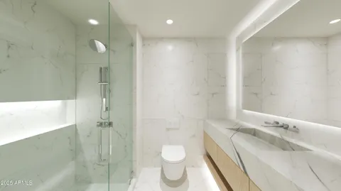 a bathroom with a double vanity sink toilet and shower