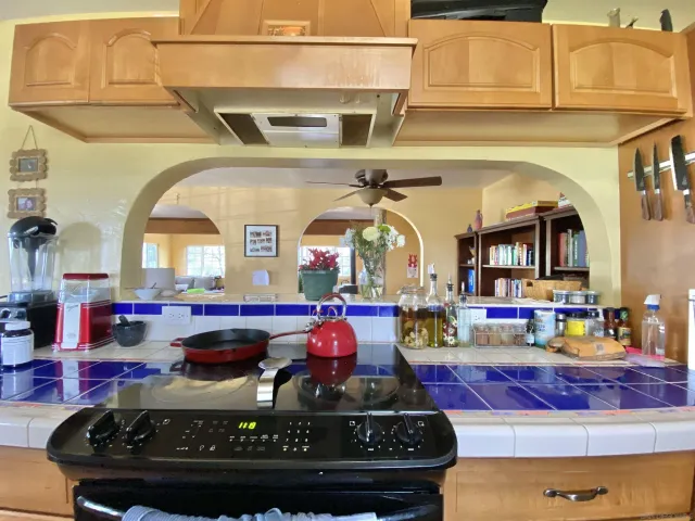 a kitchen with stainless steel appliances kitchen island granite countertop a stove and cabinets