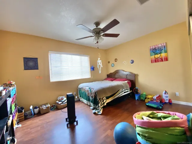 a bedroom with bed and window