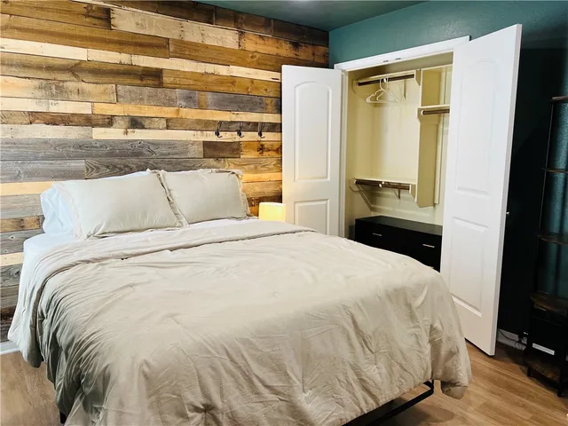 a large bed sitting in a bedroom next to a window