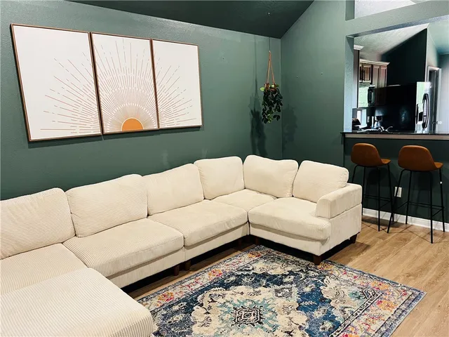 a kitchen with a table chairs sink and cabinets