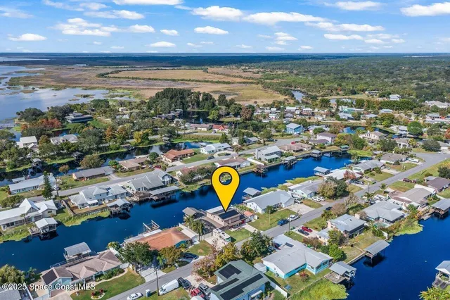 a view of a swimming pool with outdoor seating and a lots of residential buildings