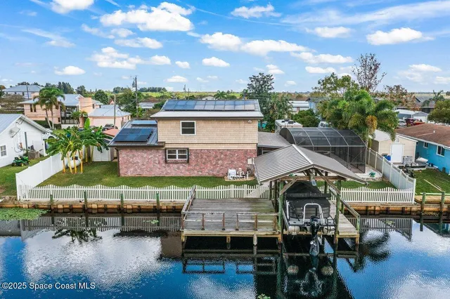 a view of a chairs and table in a backyard