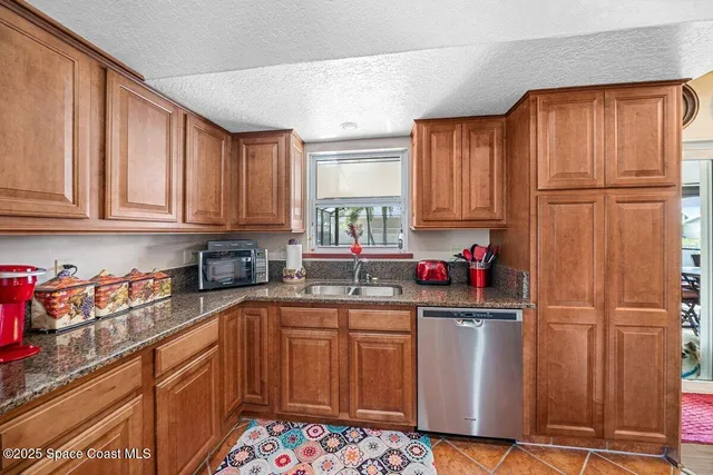 a white house covered with tall trees