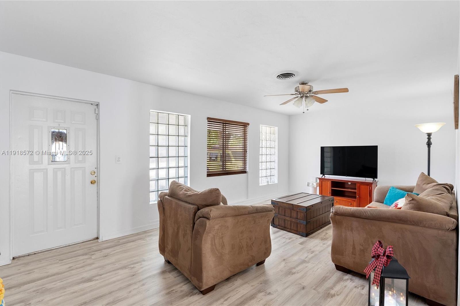 2012 Northwest 11th Avenue Fort Lauderdale, FL 33311 - Photo 3 of 15 a living room with furniture and a flat screen tv