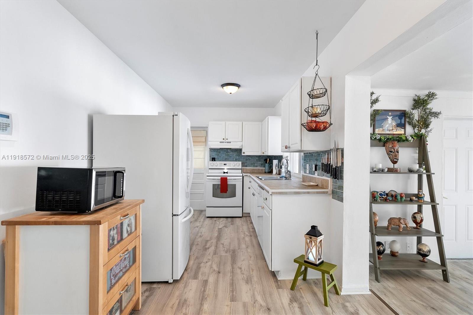 2012 Northwest 11th Avenue Fort Lauderdale, FL 33311 - Photo 5 of 15 a kitchen with stainless steel appliances kitchen island granite countertop a refrigerator a stove top oven a sink and dishwasher
