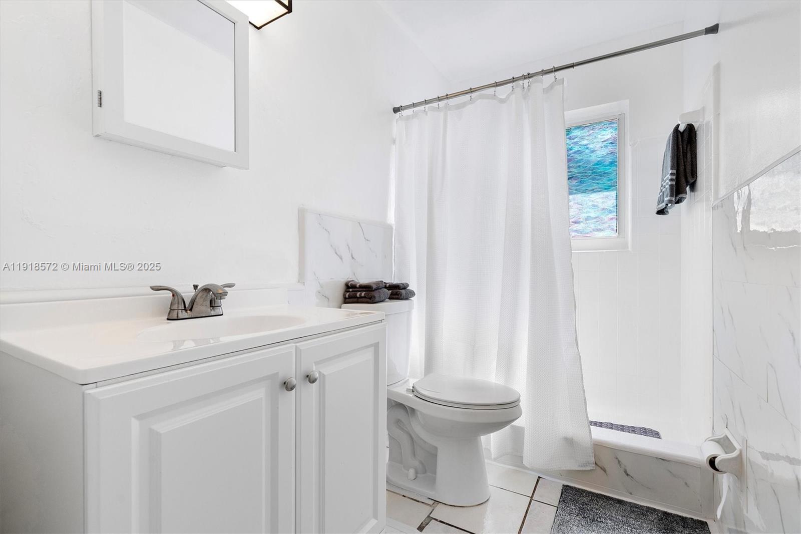 2012 Northwest 11th Avenue Fort Lauderdale, FL 33311 - Photo 10 of 15 a bathroom with a sink a toilet and shower