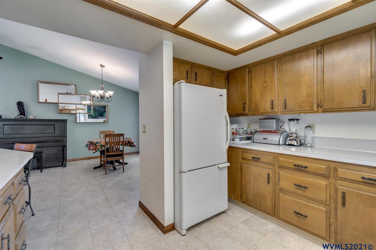 4695 Herrin Road Northeast Salem, OR 97305 - Photo 12 of 32 a kitchen with cabinets a refrigerator and a sink