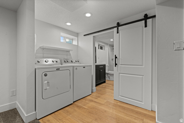 2101 West 3900th Street South Roy, UT 84067 - Photo 26 of 36 Laundry area with wood-finish flooring, recessed lighting, and a white barn door