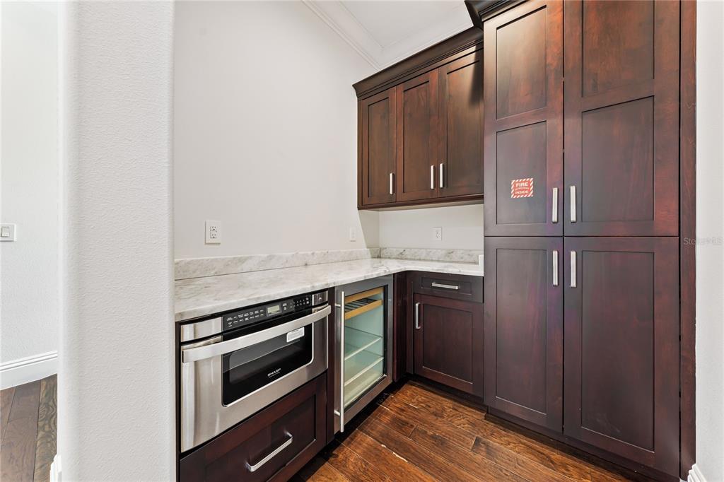 460 Muirfield Loop Reunion, FL 34747 - Photo 15 of 60 a kitchen with stainless steel appliances granite countertop a stove and a microwave