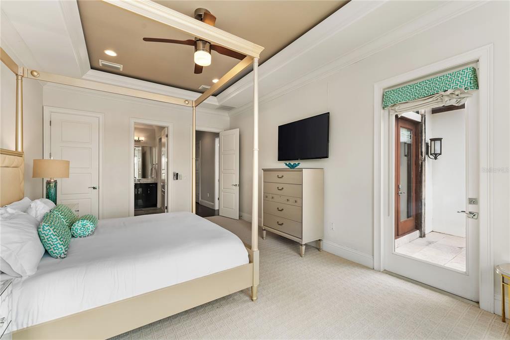 460 Muirfield Loop Reunion, FL 34747 - Photo 34 of 60 a spacious bedroom with a bed and a flat screen tv