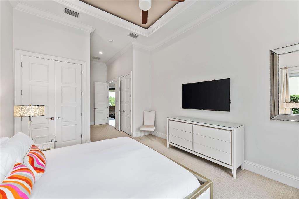 460 Muirfield Loop Reunion, FL 34747 - Photo 36 of 60 a bedroom with a bed and a flat screen tv