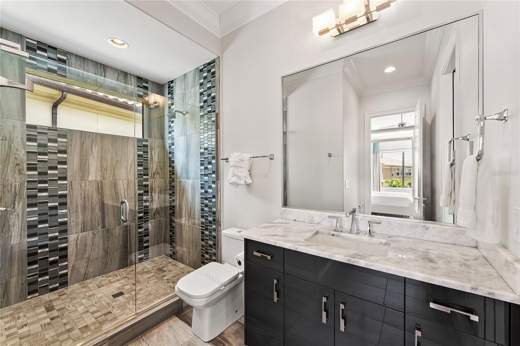 460 Muirfield Loop Reunion, FL 34747 - Photo 42 of 60 a bathroom with a granite countertop toilet sink and shower
