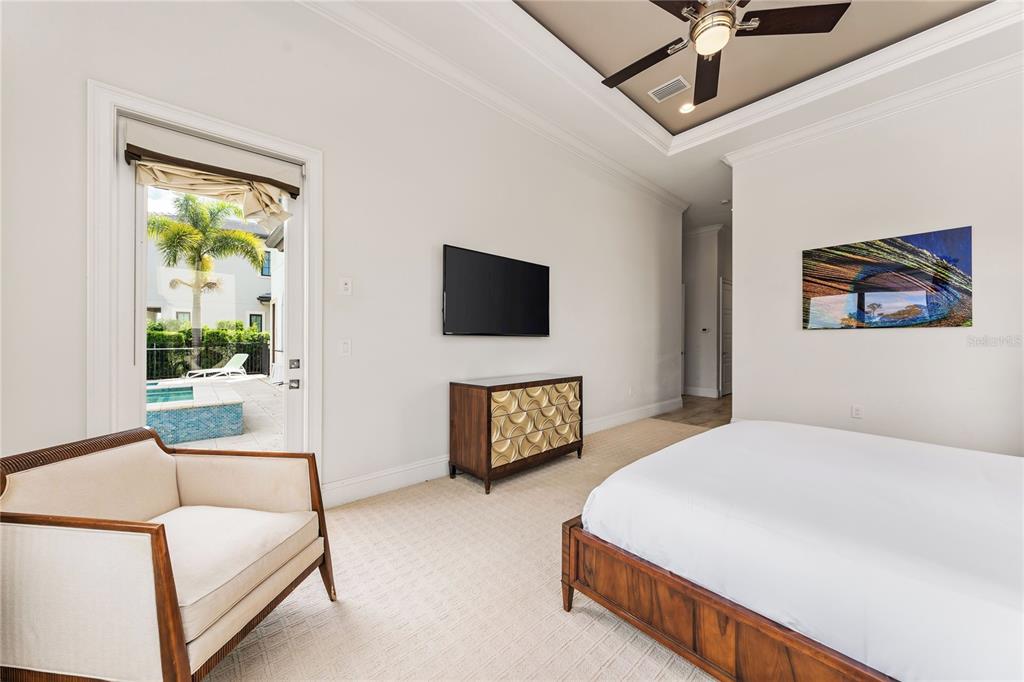 460 Muirfield Loop Reunion, FL 34747 - Photo 44 of 60 a bedroom with a bed and a flat screen tv