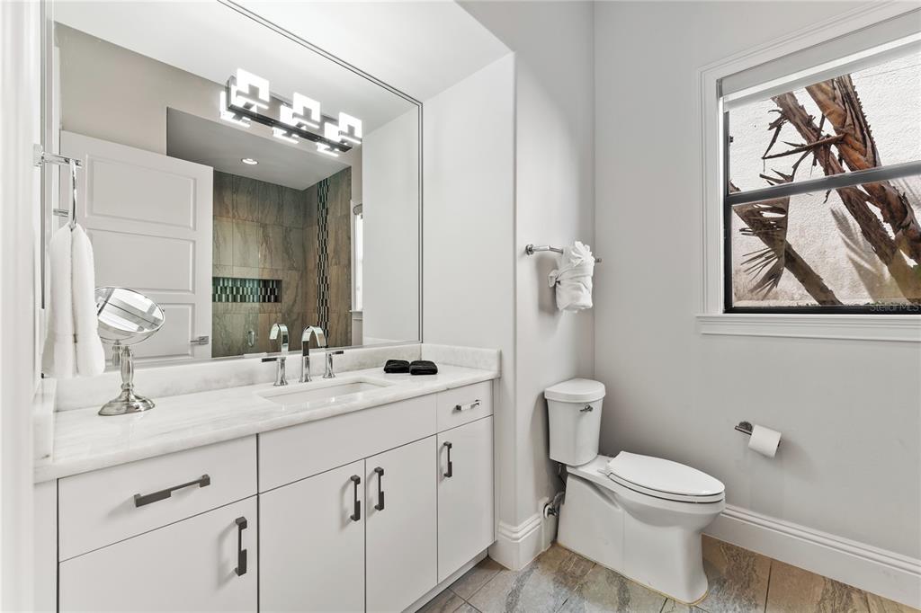 460 Muirfield Loop Reunion, FL 34747 - Photo 45 of 60 a bathroom with a toilet a sink a vanity and mirror
