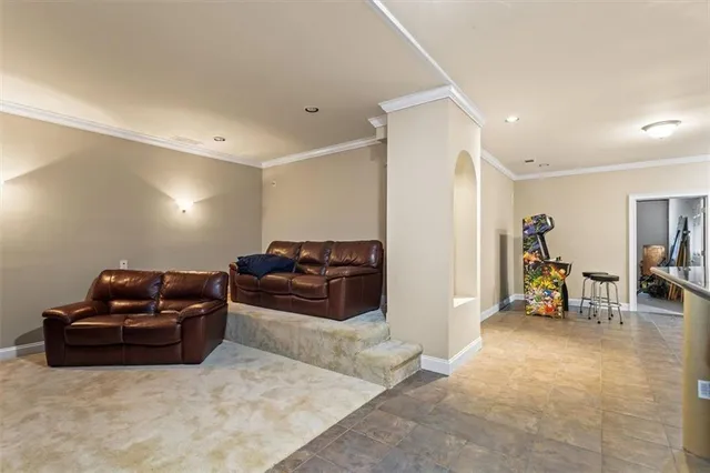 a living room with furniture a couch and a flat screen tv
