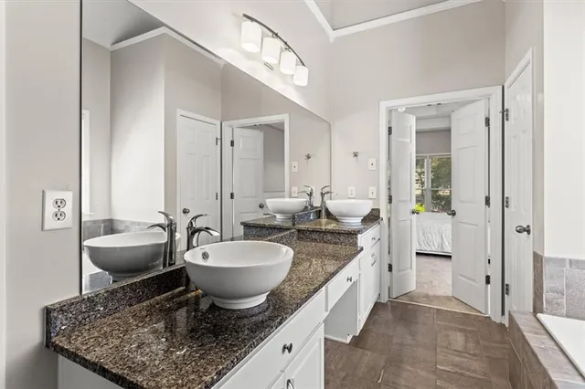 a spacious bathroom with a granite countertop sink and a mirror