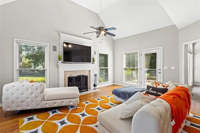 a living room with furniture a flat screen tv and a fireplace