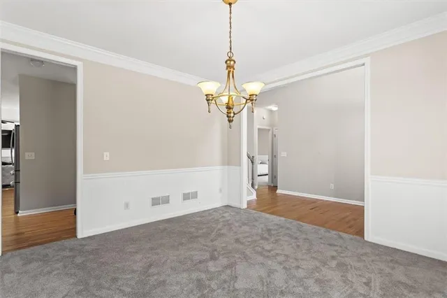 a view of a chandelier in big room and a chandelier fan