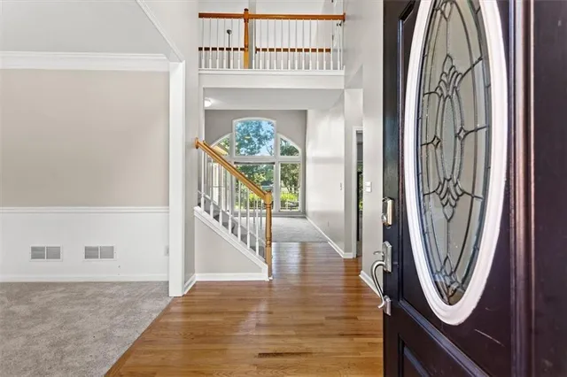 a view of a hallway with wooden floor and entryway