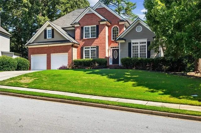 a front view of a house with a yard