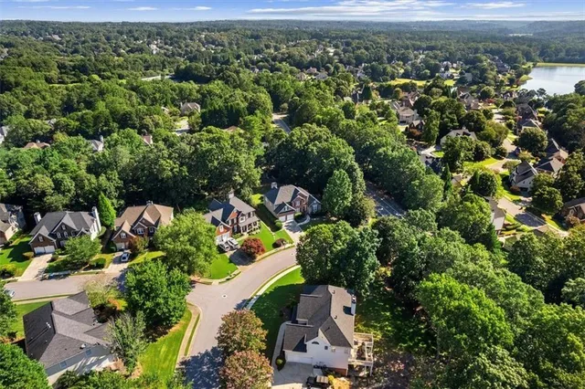 an aerial view of a houses with a yard