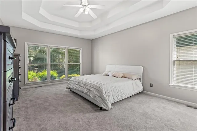 a large bed sitting in a room next to a window