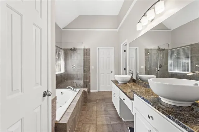a spacious bathroom with sinks granite countertop tub shower and mirror